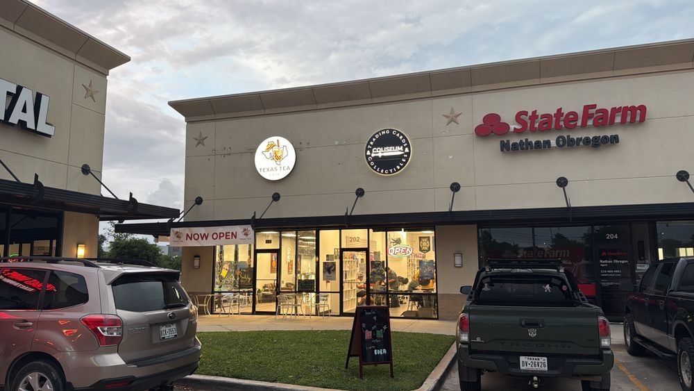 Texas Tea Café storefront at dusk with the Now Open banner and patio tables